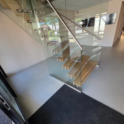 Entree van een bedrijfspand met effen marmoleum rond een zwevende trap, Harderwijk